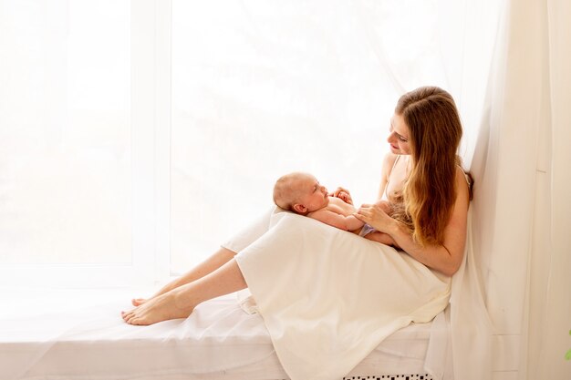 Mom playing with baby at home