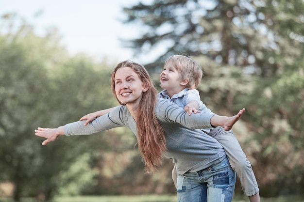 Mom plays with her little son in the park