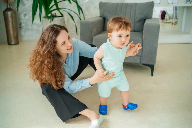 Mom sits on the floor with baby high quality photo