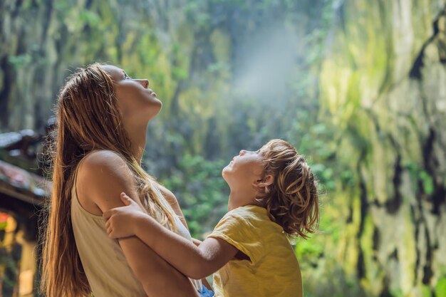 Mom and son in the background of Batu Caves, near Kuala Lumpur, Malaysia. Traveling with children concept