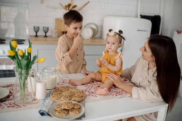 Mom son and daughter in the kitchen preparing homemade cookies