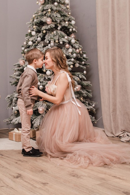 Mom and son near the Christmas tree New year concept