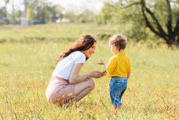 Mom and son play in the field outdoors