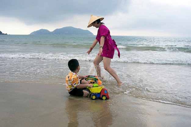 Mom and son playing on the beach