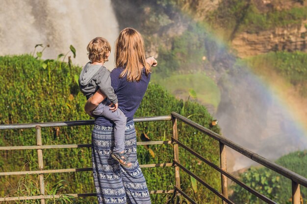 Mom and son on the surface of Majestic landscape of Elephant waterfall in summer at Lam Dong Province, Dalat, Vietnam