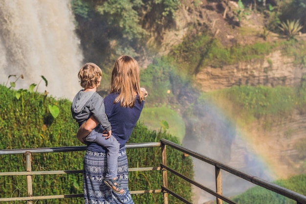 Mom and son on the surface of Majestic landscape of Elephant waterfall in summer at Lam Dong Province, Dalat, Vietnam