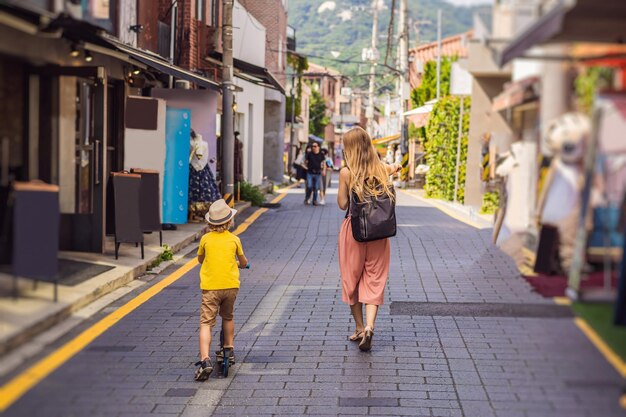 Mom and son tourists in Bukchon Hanok Village is one of the famous place for Korean traditional houses have been preserved Travel to Korea Concept Traveling with children concept