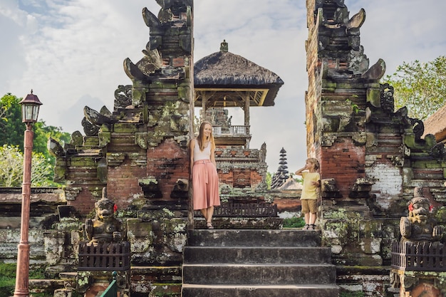 Mom and son tourists in Traditional balinese hindu Temple Taman Ayun in Mengwi. Bali, Indonesia Traveling with children concept