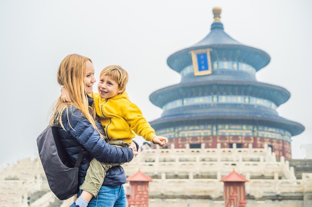 Mom and son travelers in the Temple of Heaven in Beijing One of the main attractions of Beijing Traveling with family and kids in China concept