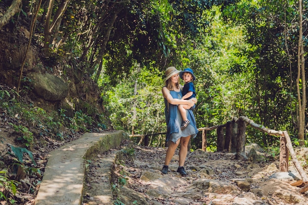 Mom and son walking on the forest road