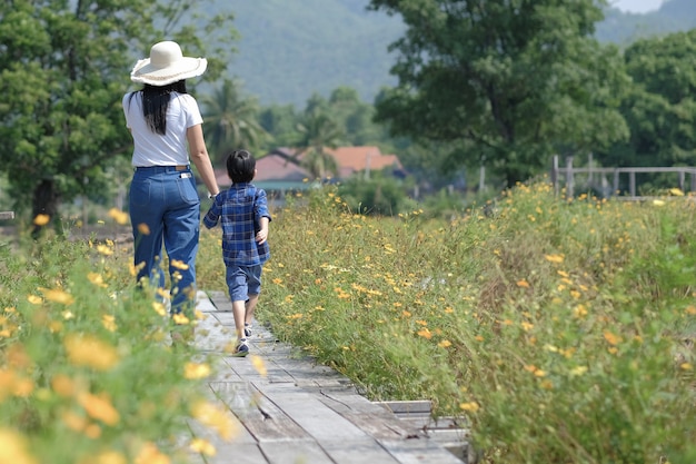 Mom and sun walking in a nature