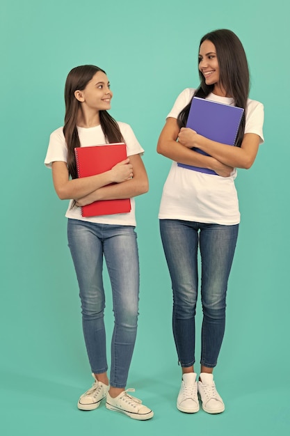 Mom and teen girl study private teacher and child holding copybooks family help