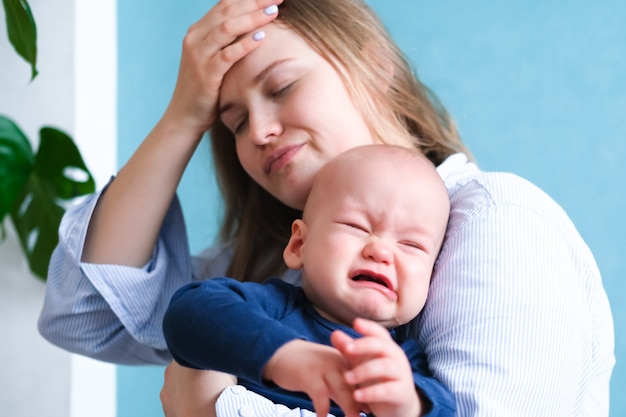 Mom tired trying to calm her crying baby