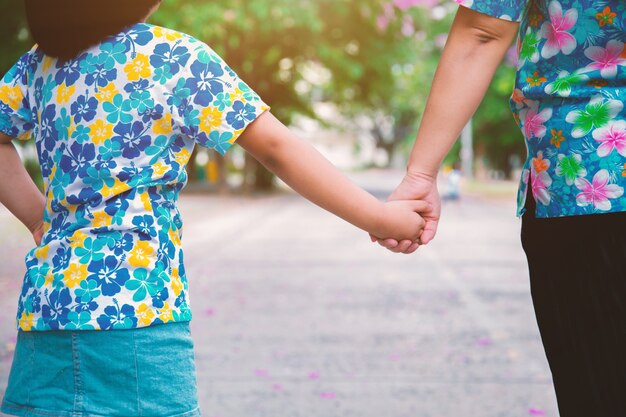 Mom walked in hand in the park.