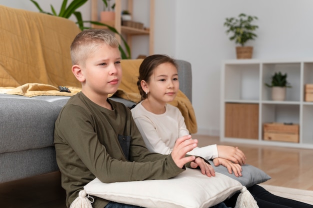 Mom watching television with her children