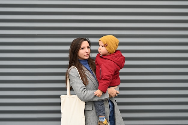 Mom with toddler boy on gray