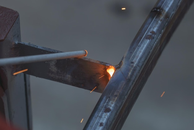 The moment of welding with an electrode a lot of sparks and smoke welding work