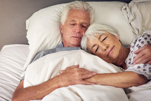 Photo moments like this are priceless shot of a senior couple sleeping in bed