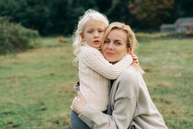 Mommy and little daughter hugging on a walk