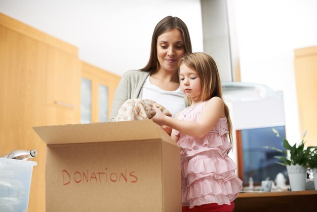 Mommys little helper A young girl helping her mother with some charity work