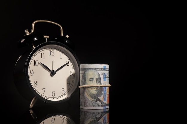 Money banknote and clock over black background