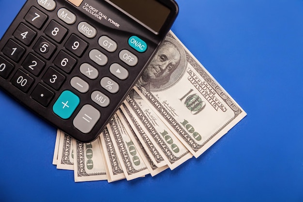 Money and calculator calculation usd banknotes and a calculator planning budget using calculator