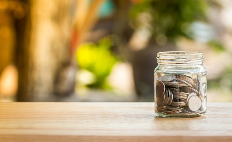 Photo money coin in glass jar for savings and financial investment concept