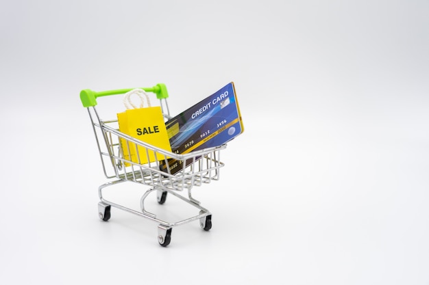 Money concept of Credit Cards in a Shopping Cart on isolate white background. 