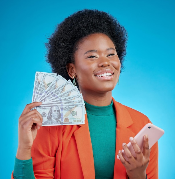 Money fan phone and woman in portrait winning finance or online savings profit and cash prize Success bonus and winner or african person on mobile cashback and banking on blue studio background