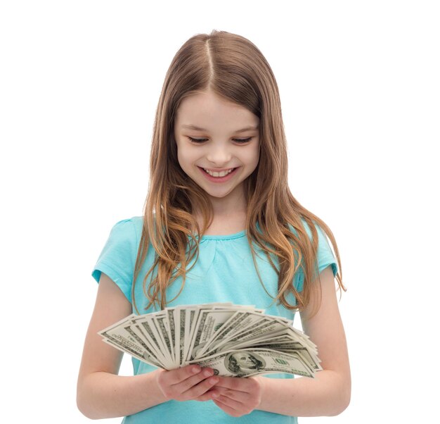 money, finances and people concept - smiling little girl looking at dollar cash money