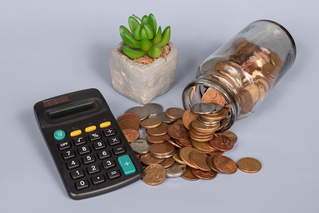 Money financial business growth concept coins in glass jar with calculator