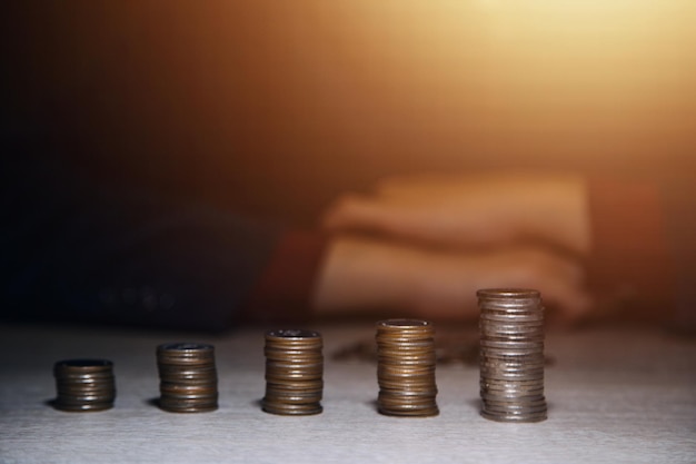 Money Financial Business Growth concept Man's hand put money coins to stack of coins