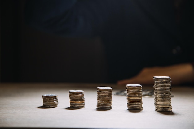 Money Financial Business Growth concept Man's hand put money coins to stack of coins