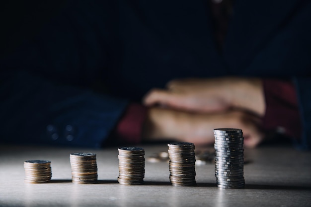 Money Financial Business Growth concept Man's hand put money coins to stack of coins