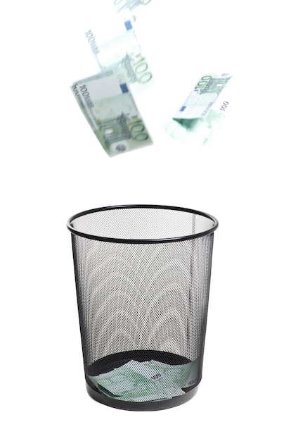 Money flying into the trash