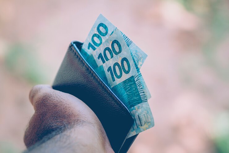 Money from Brazil. Real notes, Brazilian currency inside a black wallet. Concept of finance, economy and wealth.