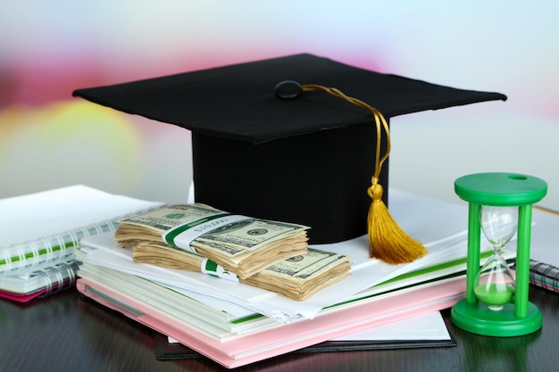 Money for graduation or training on wooden table closeup