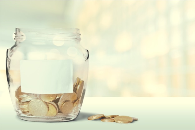 Money Jar with  coins on  background