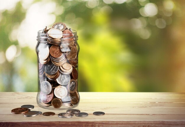 Money Jar with  coins on background