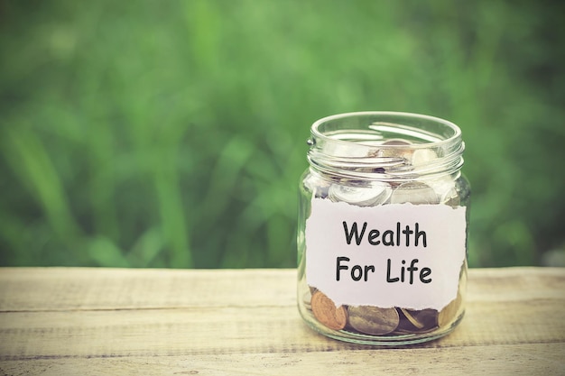 Money in the jar on wooden table