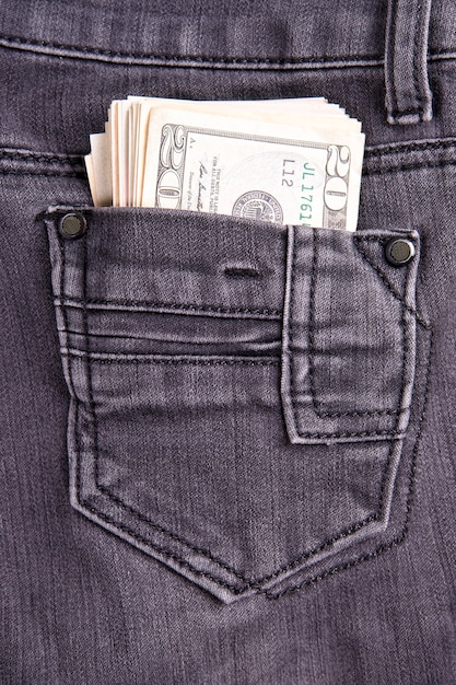 Money in the jeans pocket Dollars Twentydollar bills