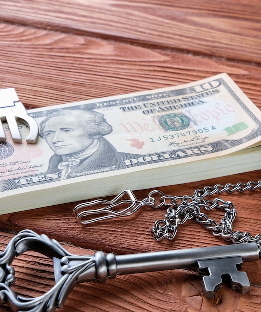 Money and keys on a wooden table