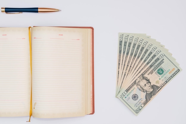 Photo money notebook and pen with white background isolated