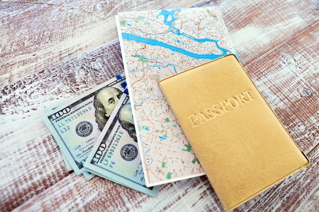 Money, passport and map for travel concept, top view