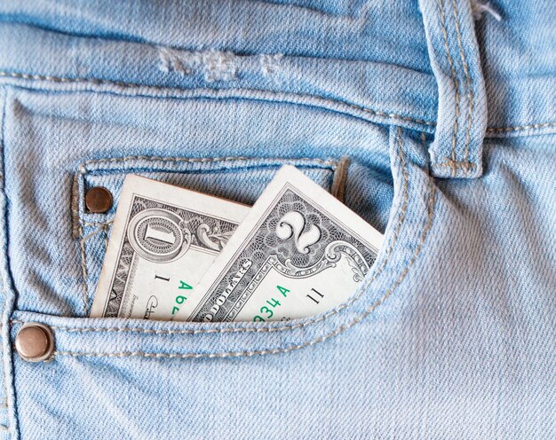 Money in the pocket of jeans A one two dollar bill in the back pocket of his jeans Pocket money