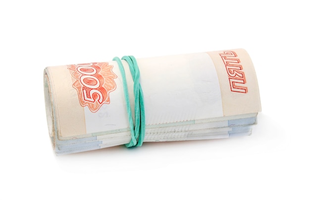 Money rolled into a tube, tapered rubber band isolated on white