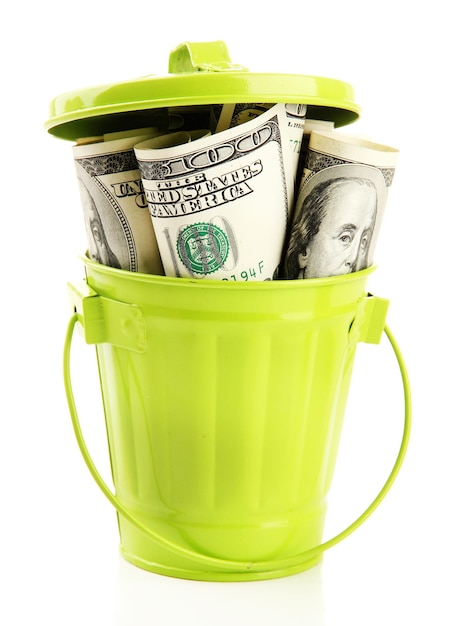 Money in trash can isolated on white