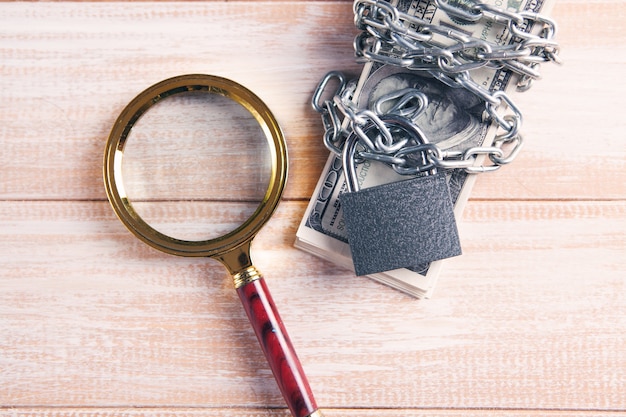 Photo money wrapped in a chain and locked with a padlock and sfpa