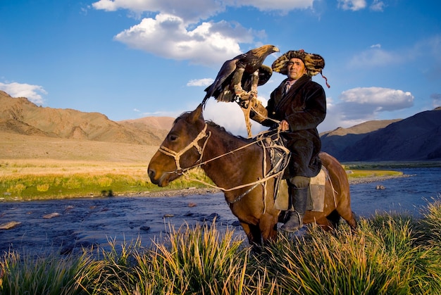 Mongolian man on a horse with an eagle