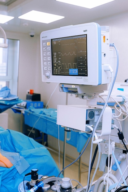 A monitor on a hospital bed with a heart rate monitor.